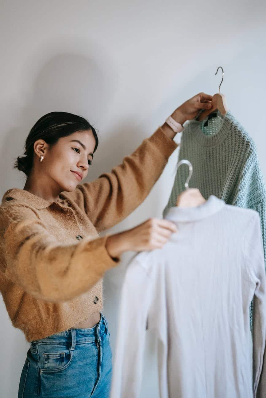 Indiana Wardrobe Stylist looking at shirts
