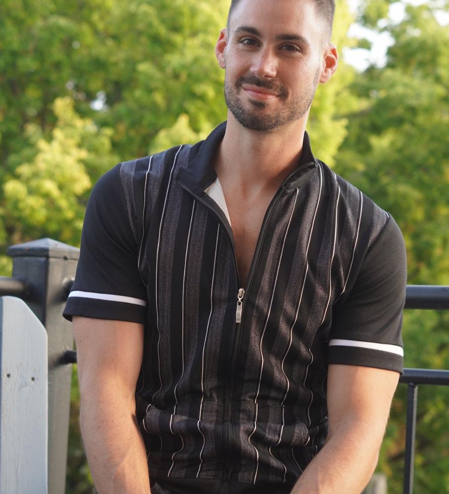 Fitted polo shirts are currently in fashion according to Men's Personal Stylists Edwards Buice and Beth Divine image shows man wearing black polo shirt
