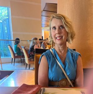 Reach out to Indiana Wardrobe Stylist Beth Divine for help evaluating your closet image shows Beth Divine with blue dress